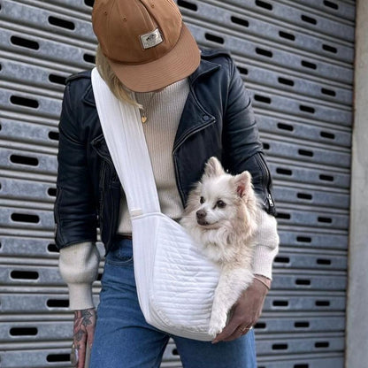 Cute white dog being carried in our white dog carrying bag. Nice quilted finish fabric. Looks cozy.