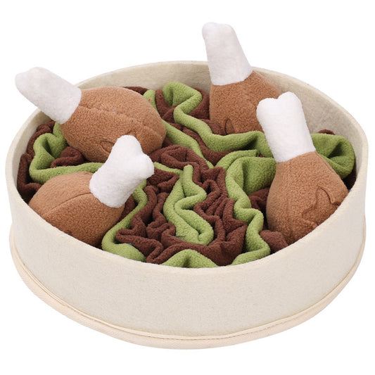 Interactive dog toy with treat finding pockets. Squeaky toys shaped like chicken legs on a bed of salad.